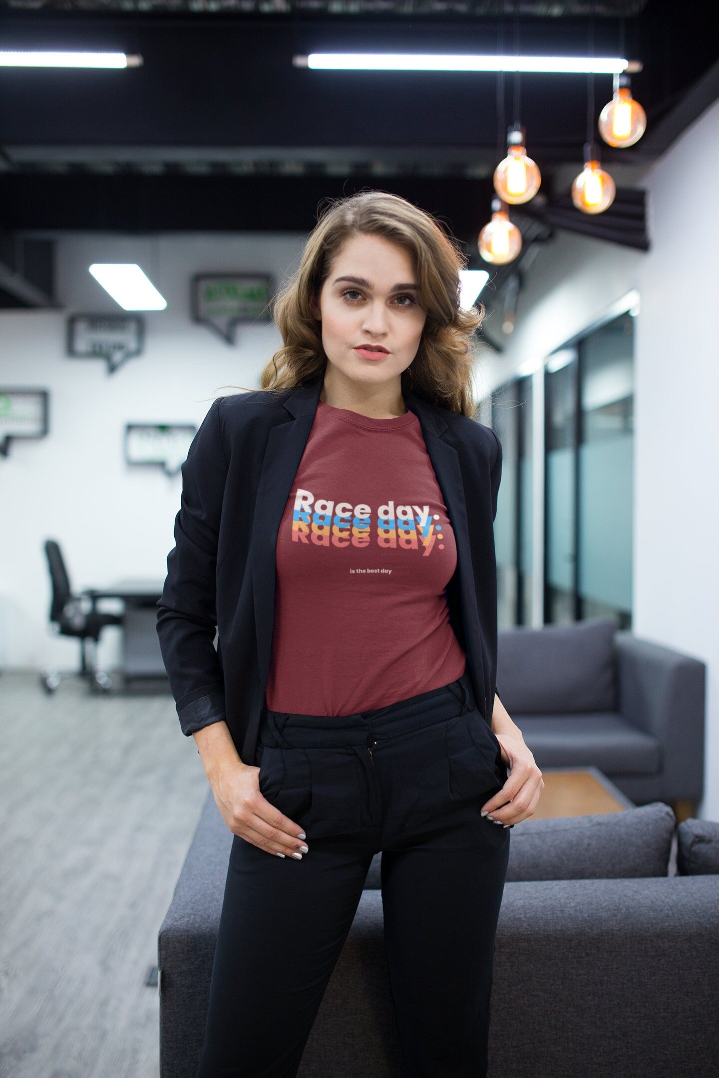 Woman wearing a red 'Race day' shirt in an office setting