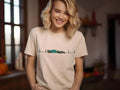 Woman wearing a beige t-shirt with a graphic design of a racing car and heartbeat line.