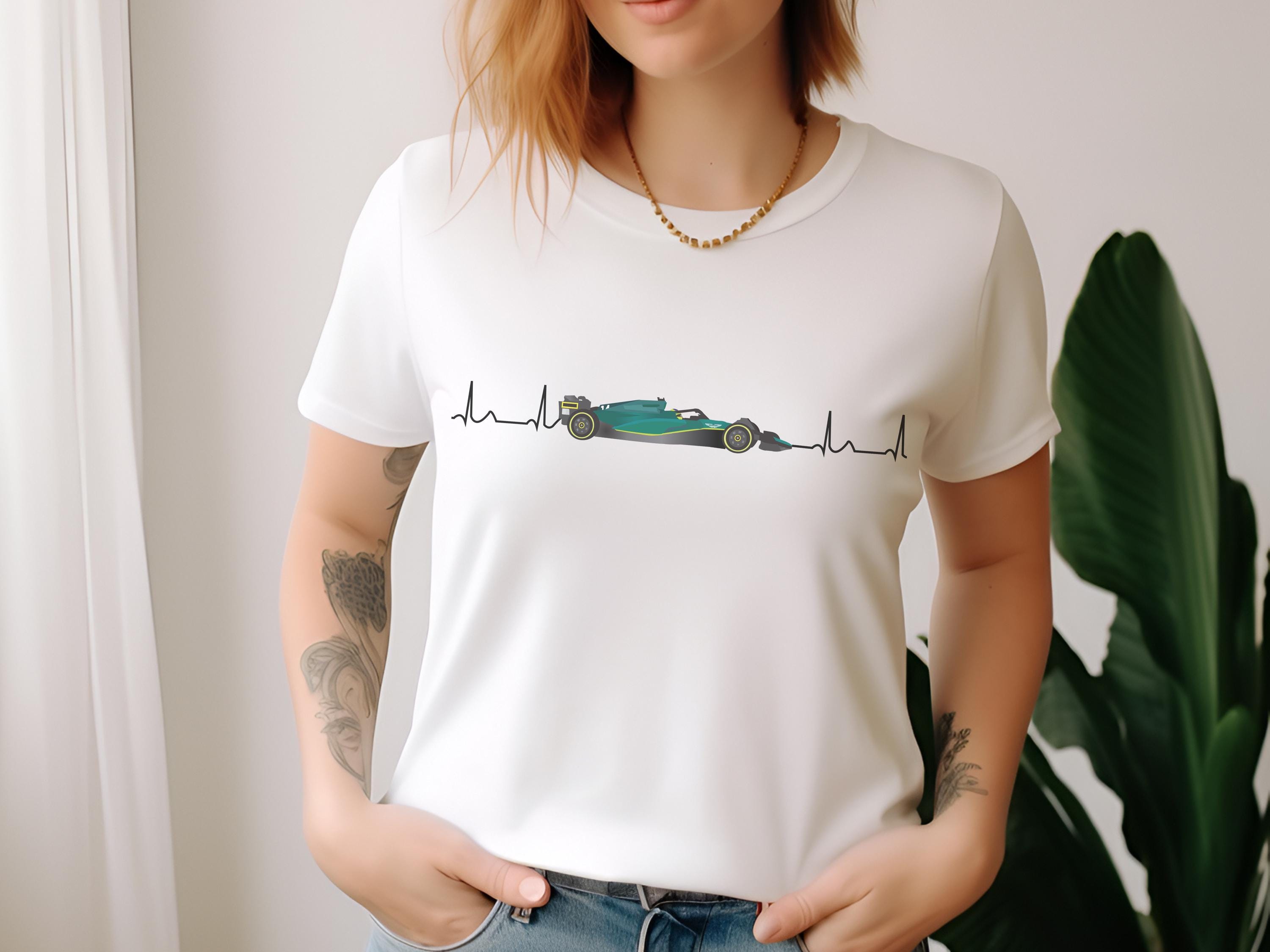 Person wearing a white t-shirt with a Formula 1 car design.