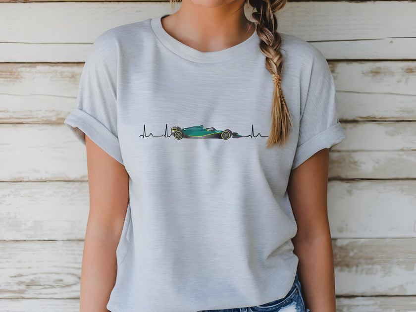 Person wearing a light gray t-shirt with a graphic design on a wooden background