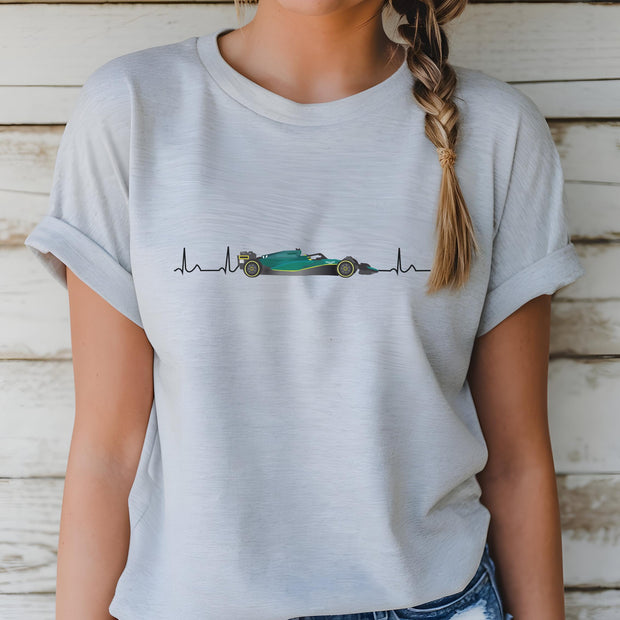 Person wearing a light gray t-shirt with a graphic design on a wooden background
