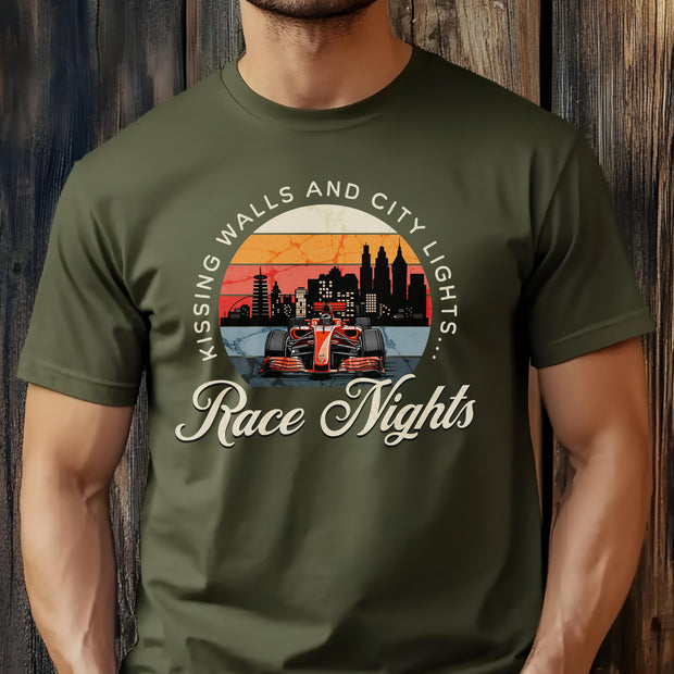 Green t-shirt with race car graphic and text 'Kissing Walls and City Lights... Race Nights' on a wooden background